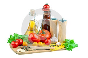 Tomatoes, tomato ketchup and tomato juice with lettuce leaves, isolated on a white background.