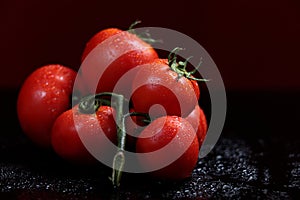 Tomatoes under water drops, red background