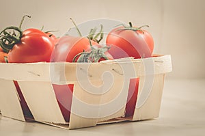 tomatoes in a wattled box/tomatoes in a wattled box on a white marble background