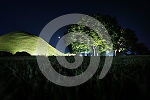 Tomb grave and trees in a park at night in Gyeongju, South Korea, Asia