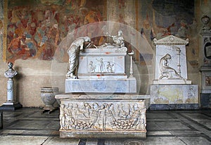 Tomb sculptures on marble tomb in medieval Camposanto Cemetery,