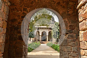 A Tomb of sikandar lodhi monument at lodi garden or lodhi gardens in a city park from the side of the lawn at winter foggy morning