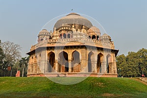 A Tomb of sikandar lodhi monument at lodi garden or lodhi gardens in a city park from the side of the lawn at winter foggy morning