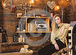 Tomboy concept. Girl tomboy spend time in house of gamekeeper. Girl in casual outfit in wooden vintage interior. Lady on photo