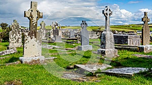 Tombs in ruins of the graveyard of the medieval church of Killilagh in the village of Doolin