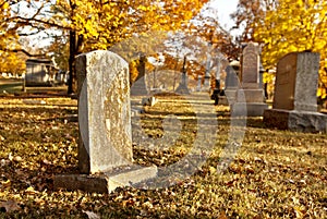 Tombstone At Cemetery In Fall