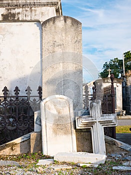 Tombstone and cross in an old lugubrious cemetery photo