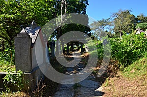 Tombstones On Grassy Field In Cemetery Against Sky