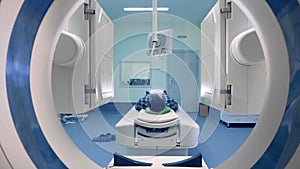 Tomograph panels move around a person. Patient on magnetic resonance imaging, medical examination.