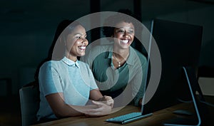 Tomorrow is for sleeping, tonight is for getting results. two young businesswomen using a computer together during a photo