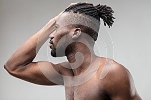 Toned black man, vanity, charm, grey background