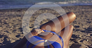 Toned Body of Woman Sunbathing at the Beach