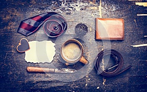 Toned concept of the day of his father, a cup of coffee, tie, belt, knife, leather wallet, place text on a postcard