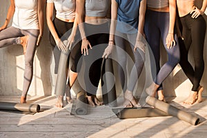 Toned female yogi in leggings waiting for yoga class photo