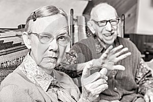 Toned Image of Angry Old Couple in Livingroom