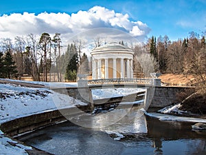 Toned image the Temple of Friendship in Pavlovsk Park (1780) in spring on the banks of the river Slavyanka