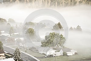 Toned photo of aerial foggy landscape of small town USA in countryside Colfax, Eastern Washington