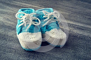 Toned photo of blue child bootees.