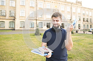 Toned Photo of Sad Student with the Book on the City Street