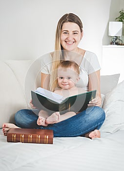 Toned portrait of young mother and her baby boy posing with big