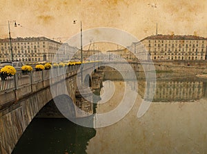 Toned vintage bridge leads to a piazza in Italy