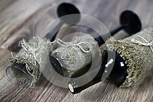 Toned wine bottle and glass on wood