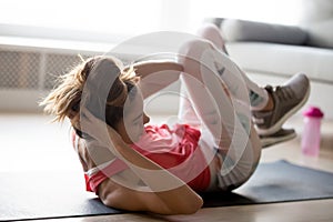 Toned woman in sportswear doing crisscross exercises photo