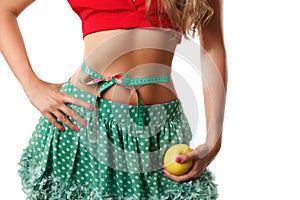 Toned woman stomach with measuring tape