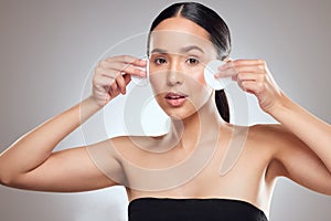 Toner can help you achieve that perfectly poreless look. Studio portrait of a beautiful young woman using a cotton pad