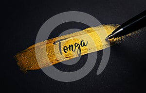 Tonga Handwriting Text on Golden Paint Brush Stroke