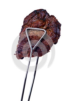 Tongs with grilled meat photo