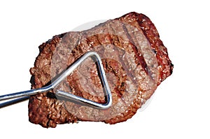 Tongs Holding Grilled Beef Loin Top Sirloin Steak photo