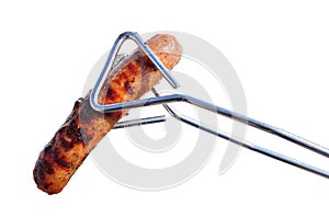 Tongs Holding a Grilled Bratwurst