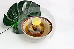 Tongseng kambing traditional food with lemon photo