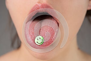 Tongue with drugs. LSD. Psychedelic hallucinogens. Drug addiction. photo