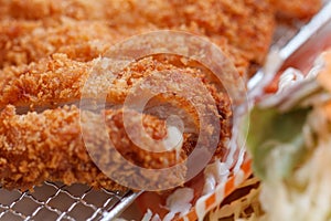 Tonkatsu is a Japanese dish which consists of a breaded, deep-fried pork cutlet Served with Vegetable and Sauce