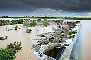 Tonle Sap River Dam spillway overflow on a rainy day