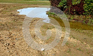 too compact and impermeable soil does not absorb water during rains and floods. photo