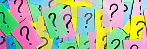 Too Many Questions. Pile of colorful paper notes with question marks. Closeup