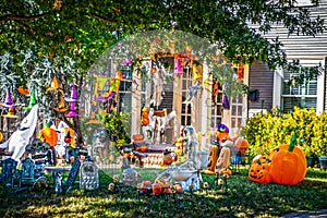 Too much Halloween - House with yard filled with Halloween decorations of every kind including skeleton on toilet seat and many