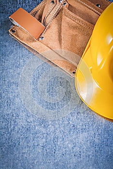 Tool belt safety building helmet on metallic background construc