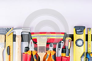 Tool belt with tools on grey background. top view, copy space.