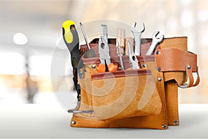 Tool belt with tools on light background