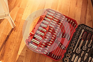 Tool box,set of bits and wrenches on laminated floor.
