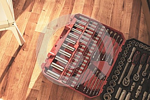 Tool box,set of bits and wrenches on laminated floor.