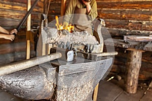 Tool in the forge against the background of the fire.