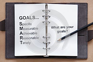 Tool of setting goal and what are your goals words on organizer book with pencil