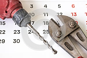A tool for snacking metal rods and a puncher on a sheet of calendar