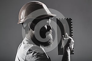 Tool, trowel, handyman, man builder. Mason tools, builder. Bearded man worker, beard, building helmet, hard hat