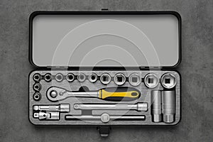 Toolbox for the car repair. Ratchet and bits tool kit. Socket wrench and ratchet heads. Tool kit on a gray background. Top view
